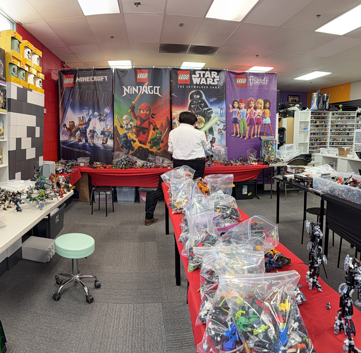 Tables covered in bagged LEGO pieces and sets from a collection brought in to sell