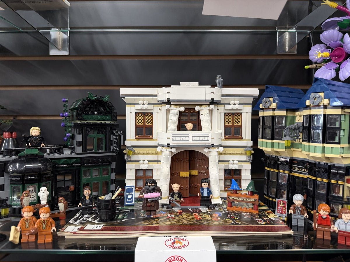 A retired LEGO modular building set on display with minifigures and an Arizona Brick Co. price tag