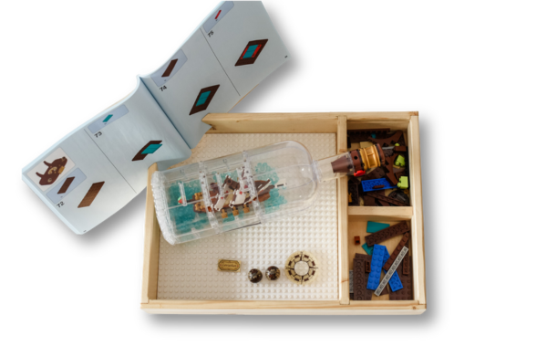 The TRĀ holding a LEGO® set in progress with instructions propped up and parts sorted in the compartments