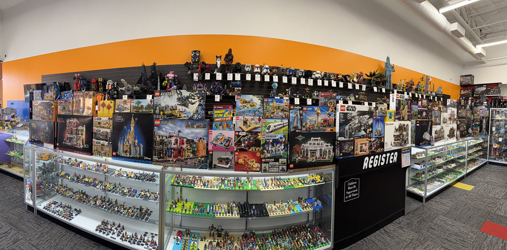Wide view inside Arizona Brick Co. showing display cases, shelves of sets, and the minifigure counter